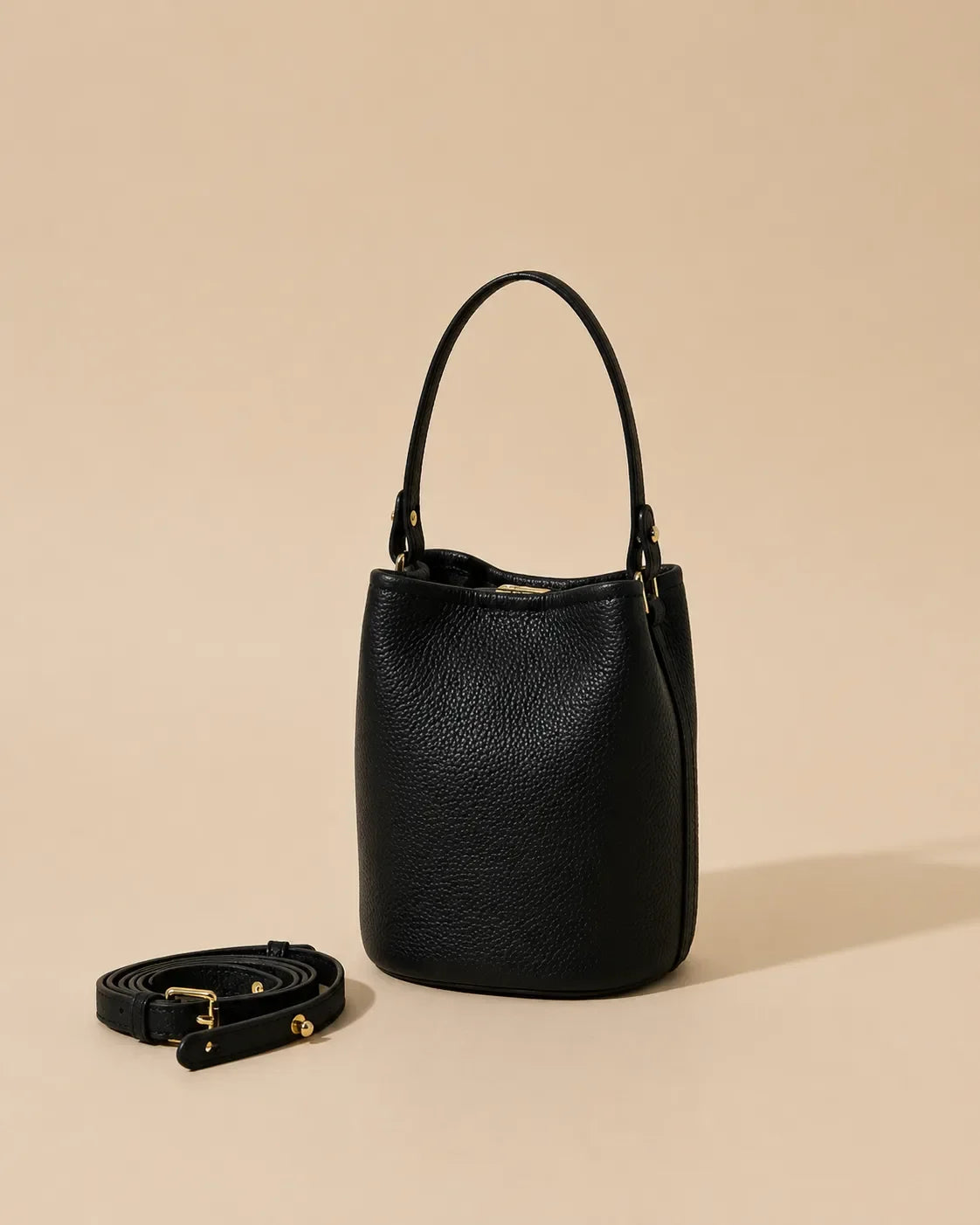 Bonnie genuine leather bucket bag in Black with adjustable strap, compact bucket silhouette and premium pebbled leather finish