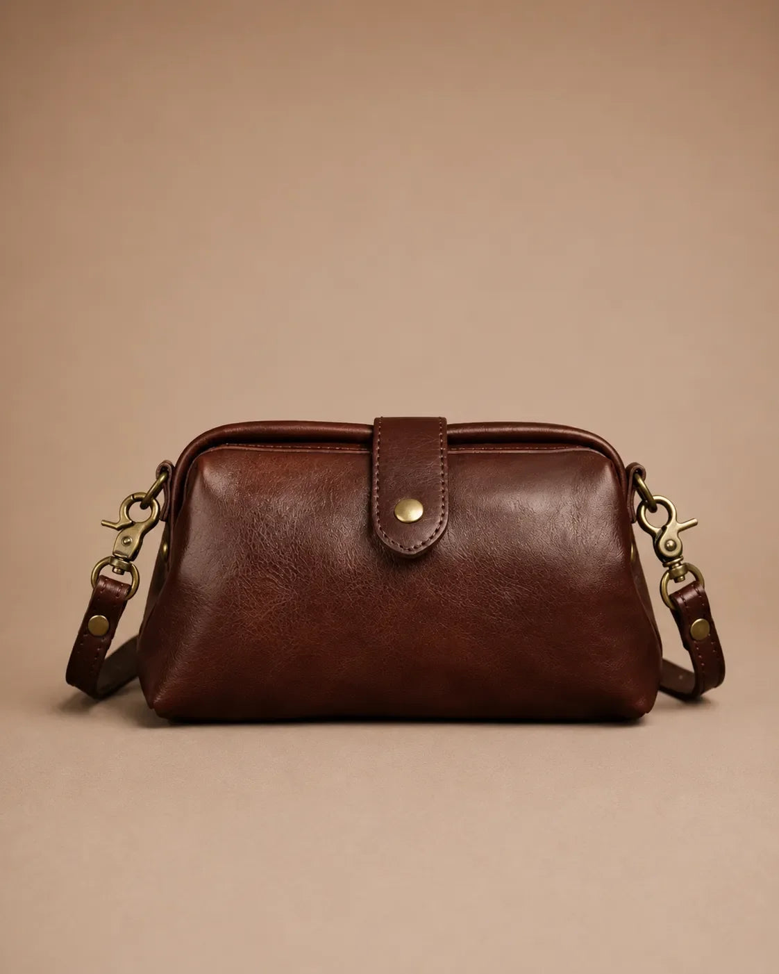 Front view of the Eloise leather crossbody bag in dark chocolate genuine leather with vintage-inspired brass hardware.