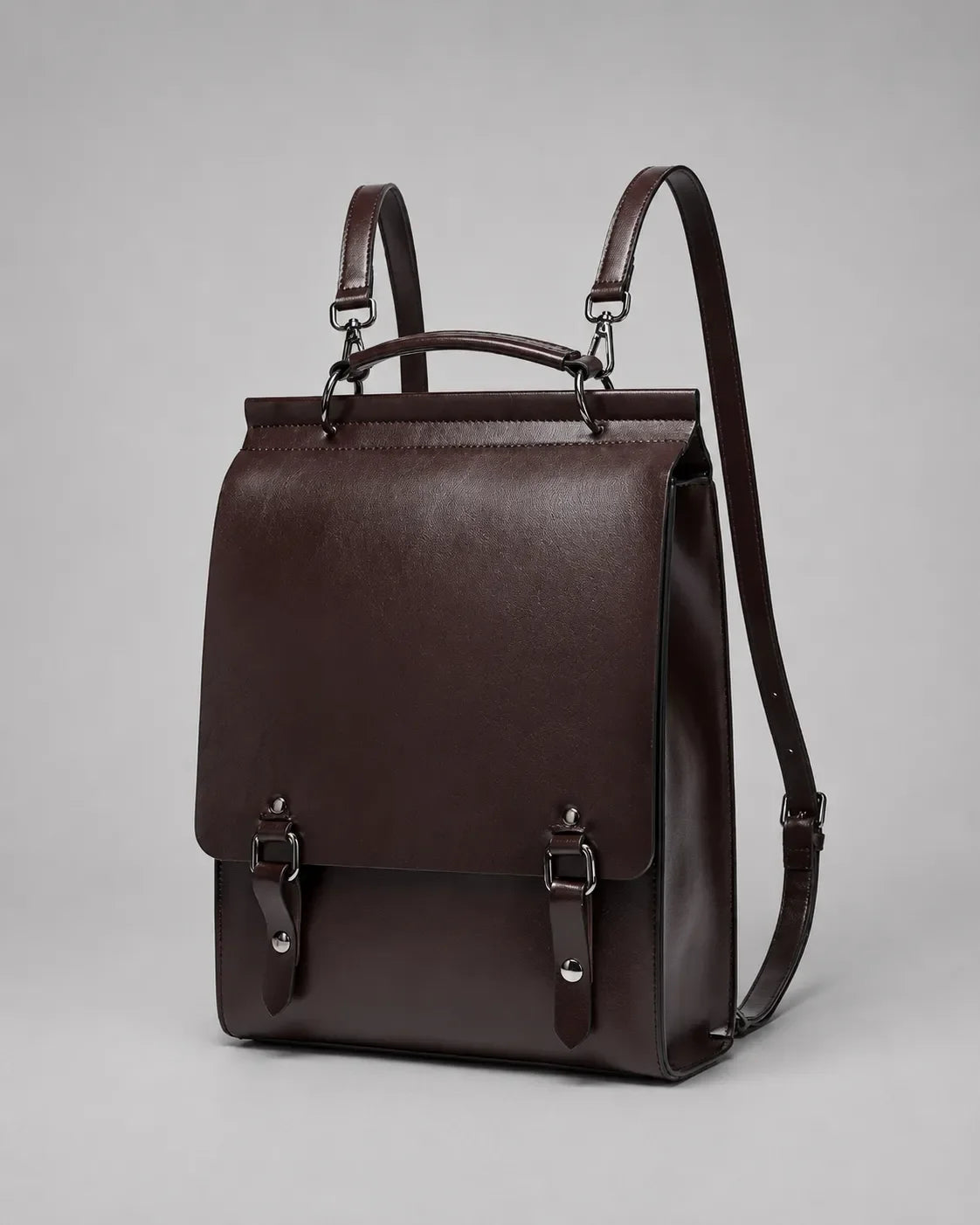 Angled view of the Heritage Leather Backpack crafted from Dark Chocolate genuine leather with adjustable straps, structured body and premium metal hardware.