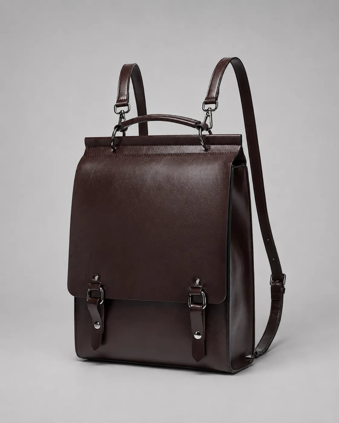 Angled view of the Heritage Leather Backpack crafted from Dark Chocolate genuine leather with adjustable straps, structured body and premium metal hardware.