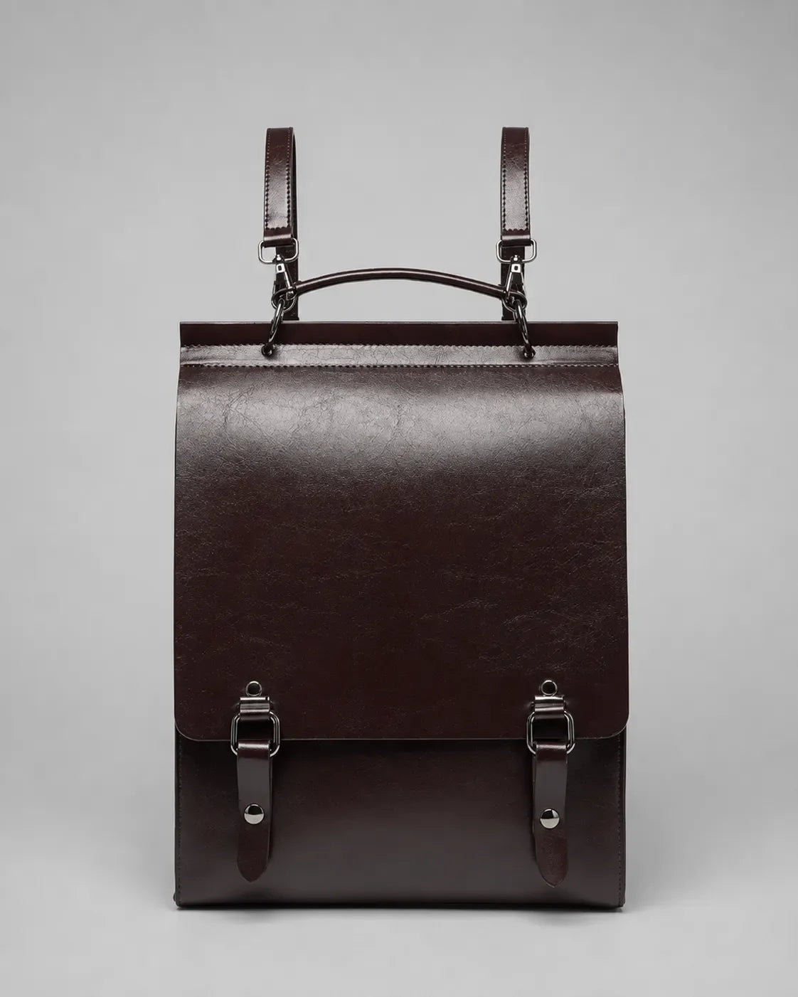 Front view of the Heritage Leather Backpack in Dark Chocolate genuine leather featuring flap closure, premium hardware and structured vintage-inspired design.