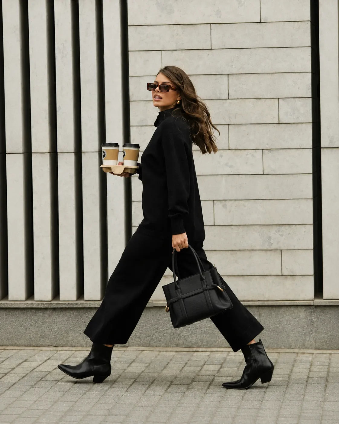 Stylish woman carrying a Malena London genuine leather bag in an urban lifestyle scene, representing the brand's commitment to quality, reliability and timeless European elegance.