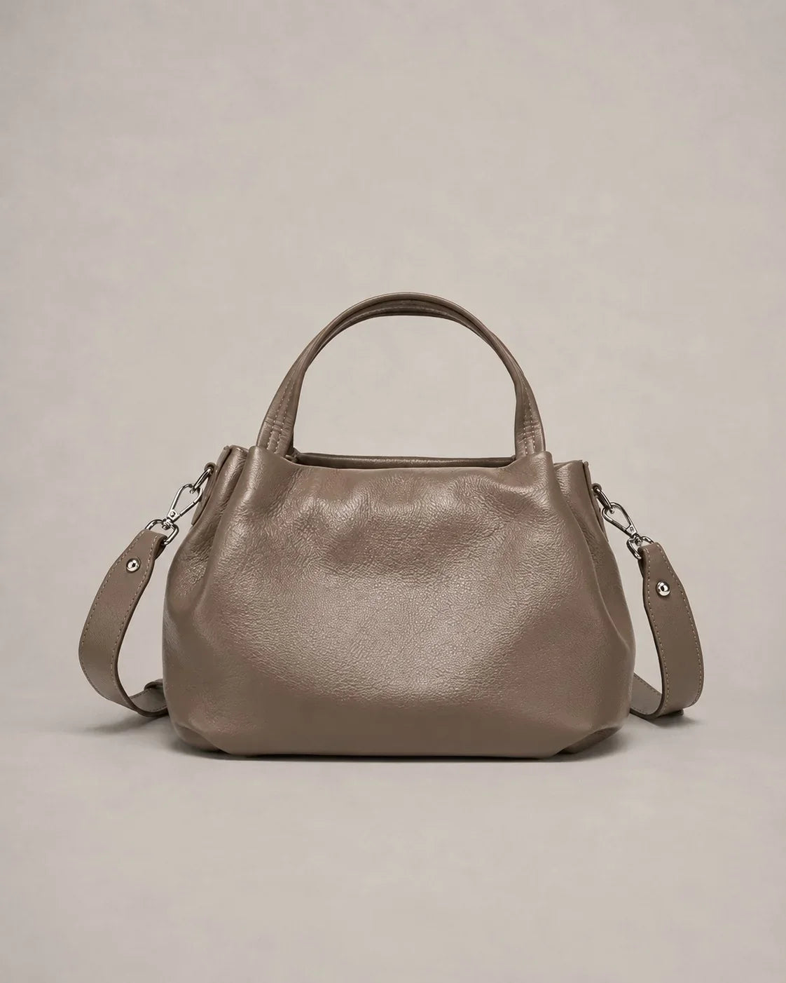 Front view of the Pauline genuine leather top handle crossbody bag in taupe featuring a softly structured silhouette, premium pebbled leather and adjustable shoulder strap by Malena London.