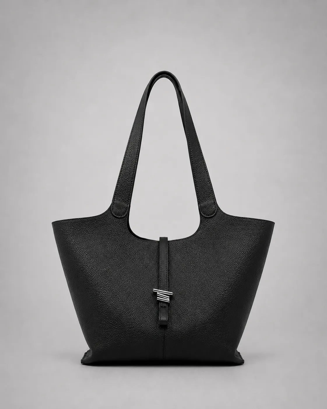 Victoria genuine leather work tote bag in black displayed from the front, featuring a spacious silhouette, elegant shoulder straps and a refined minimalist aesthetic.