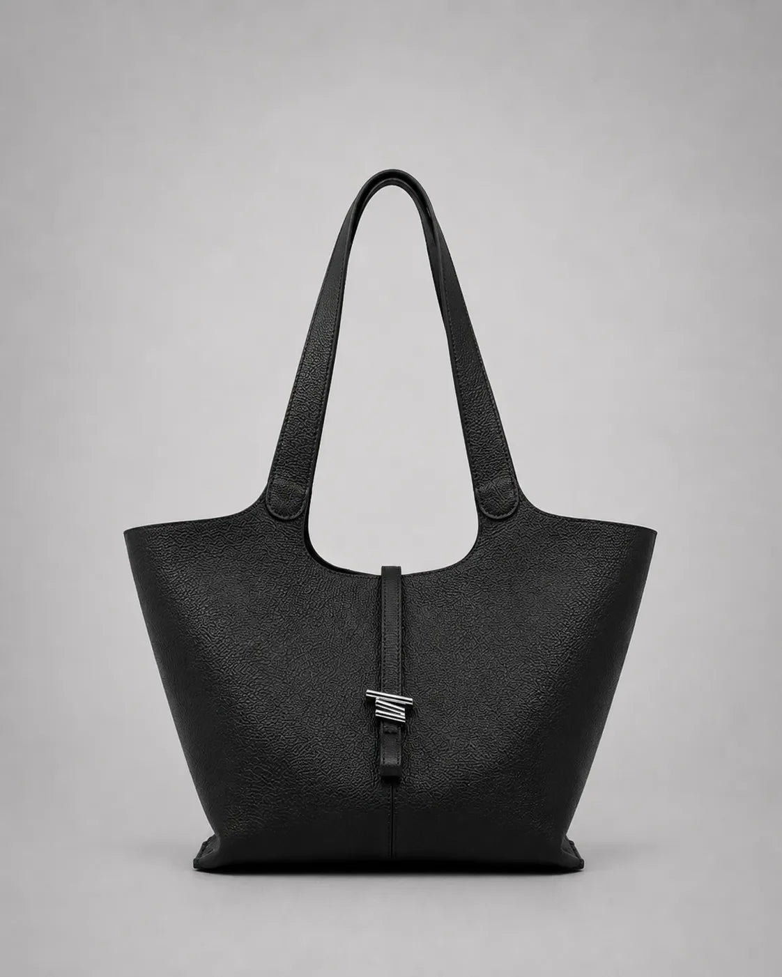 Victoria genuine leather work tote bag in black displayed from the front, featuring a spacious silhouette, elegant shoulder straps and a refined minimalist aesthetic.