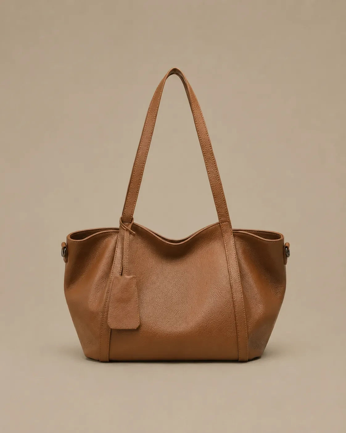 The Viney genuine leather shoulder bag in Brown featuring a soft structured silhouette and spacious everyday design by Malena London.