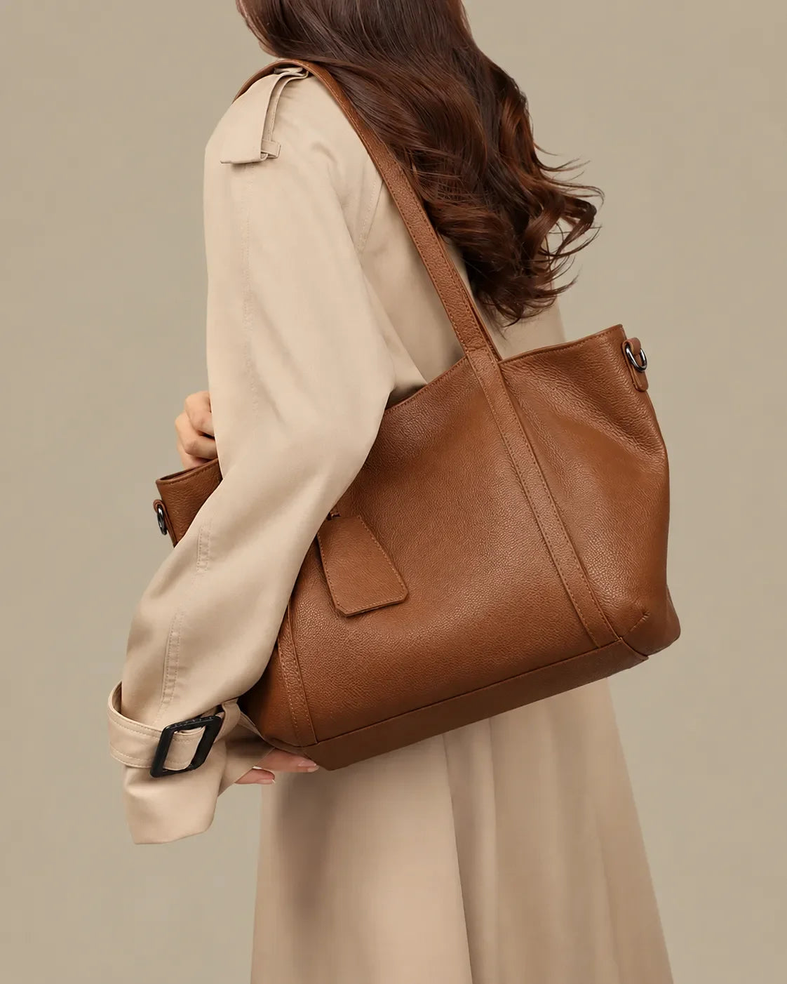 Rear view of a model carrying The Viney genuine leather shoulder bag in Brown, showcasing its elegant everyday silhouette and comfortable shoulder fit.