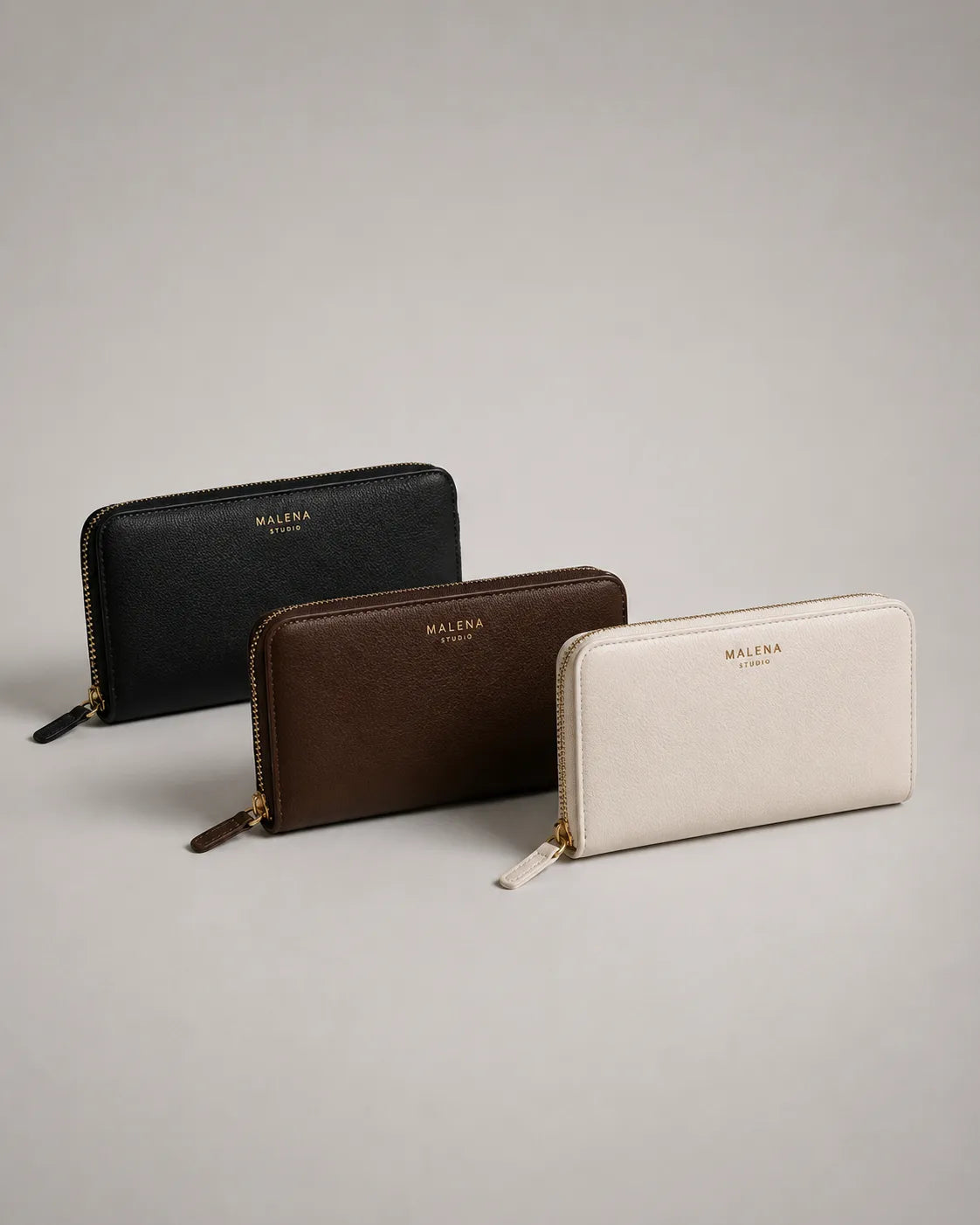 Collection of genuine leather wallets in black, dark brown and cream leather, featuring zip-around designs and minimalist detailing. Part of the Malena London Leather Wallets collection.