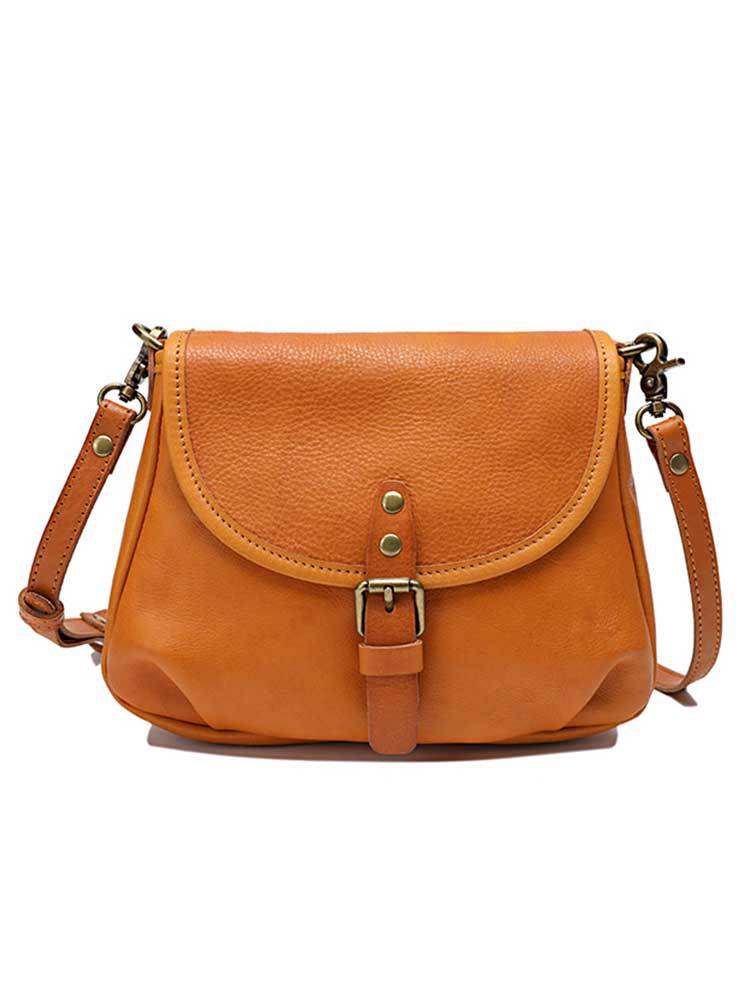 Vintage genuine leather shoulder bag in tan with a buckled flap, brass-tone hardware and an adjustable strap on a plain white background, by Malena London