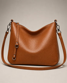 Front view of the Noémie soft genuine leather hobo shoulder bag in brown showing the relaxed silhouette and double straps.
