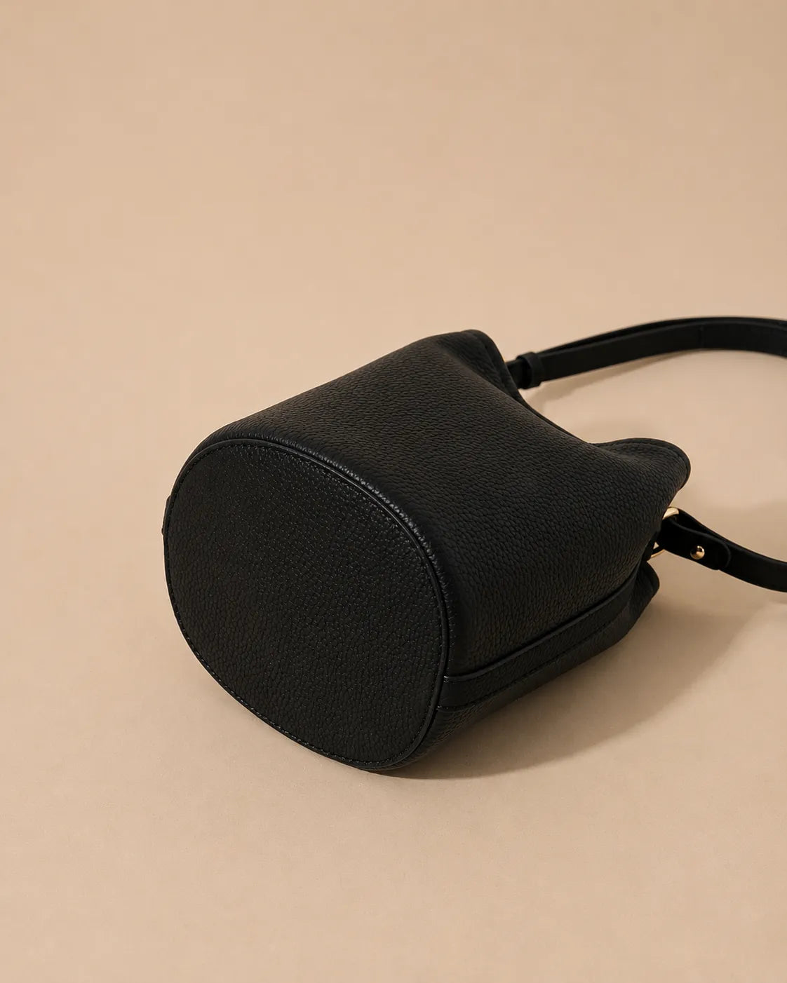 Bottom view of the Bonnie genuine leather bucket bag in Black highlighting the rounded structured base and premium pebbled leather construction