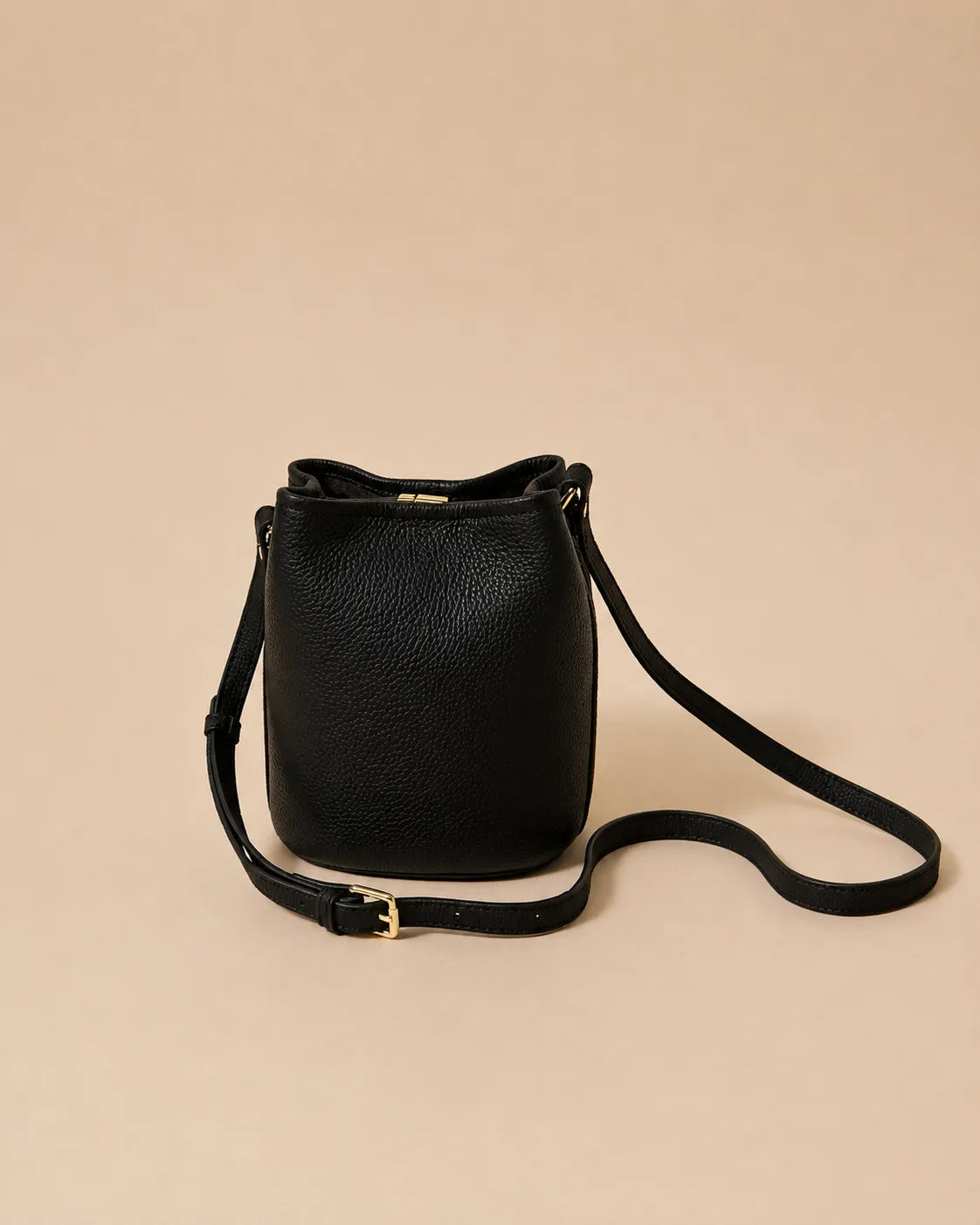 Bonnie genuine leather bucket bag in Black displayed with the adjustable crossbody strap for versatile everyday wear and hands-free styling