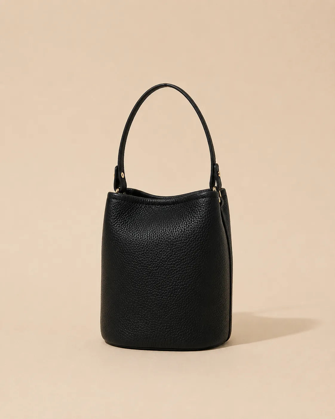 Front view of the Bonnie genuine leather bucket bag in Black featuring a soft structured bucket silhouette and premium pebbled leather finish