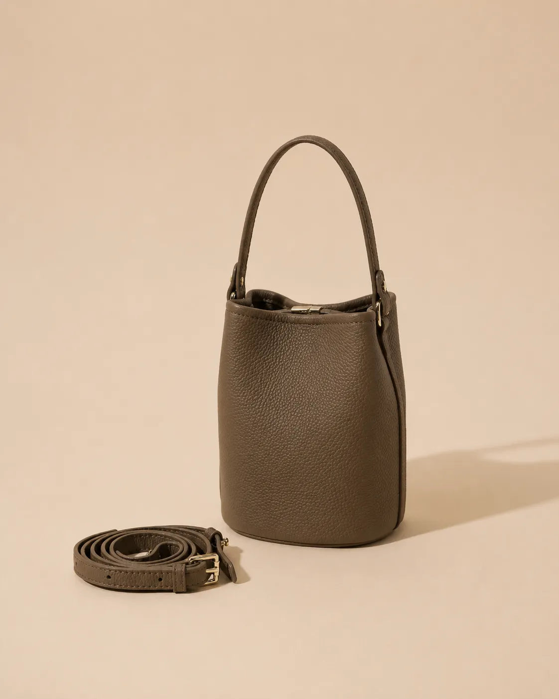 Front view of the Bonnie genuine leather bucket bag in Dark Grey featuring a compact bucket silhouette, soft structure and adjustable leather strap