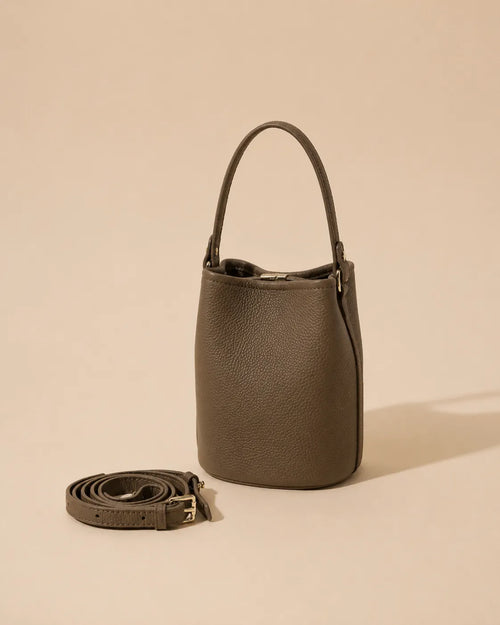 Front view of the Bonnie genuine leather bucket bag in Dark Grey featuring a compact bucket silhouette, soft structure and adjustable leather strap