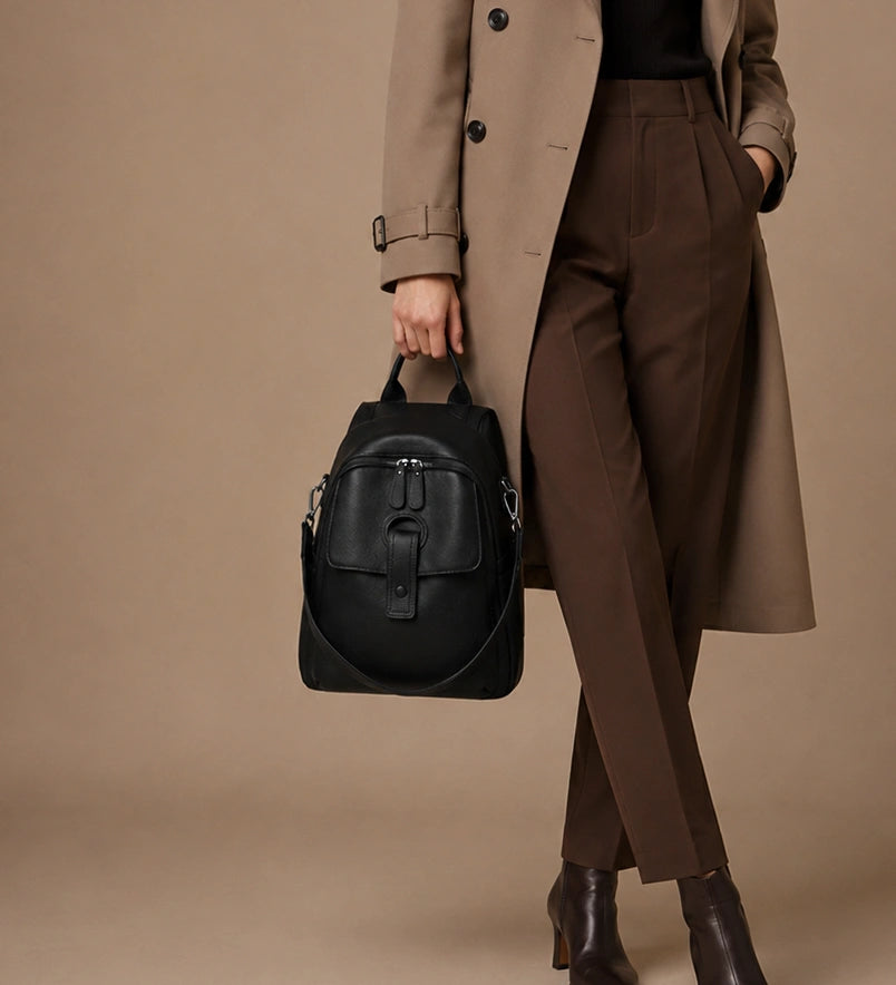 Sloane leather backpack worn crossbody using the included wide woven strap.