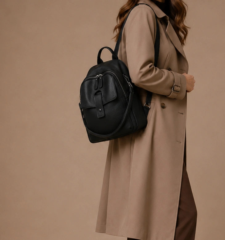 Close-up of the Sloane leather backpack's front magnetic-snap pocket.