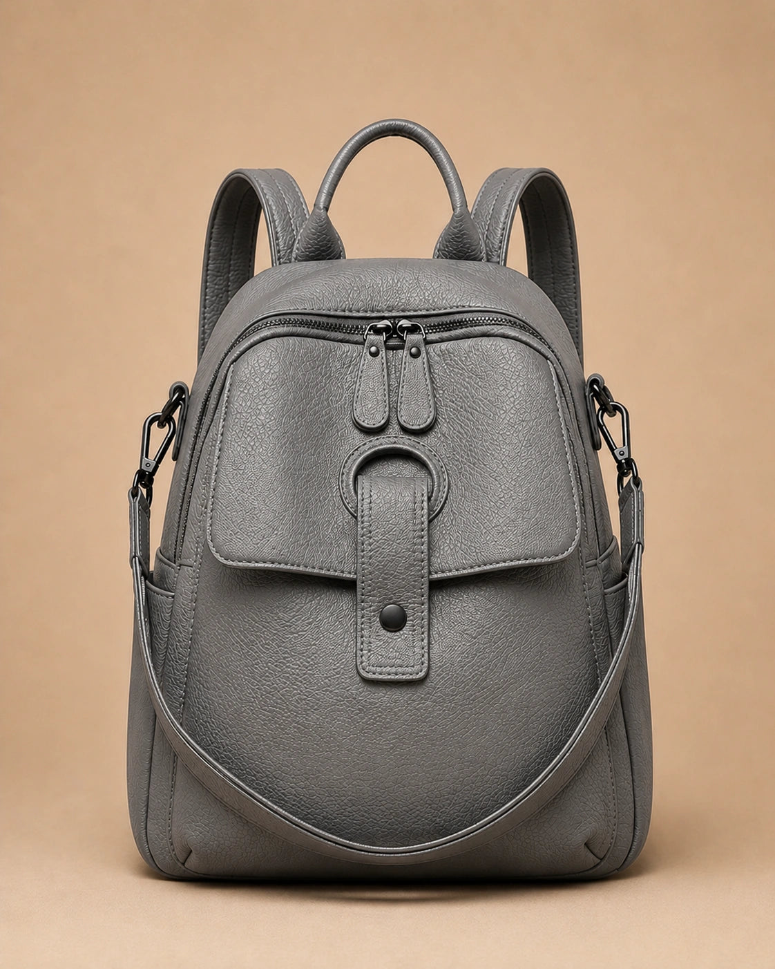 Sloane leather backpack shown with the included wide woven strap detached.
