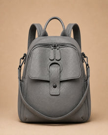 Sloane leather backpack shown with the included wide woven strap detached.