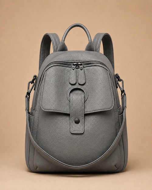 Sloane leather backpack shown with the included wide woven strap detached.