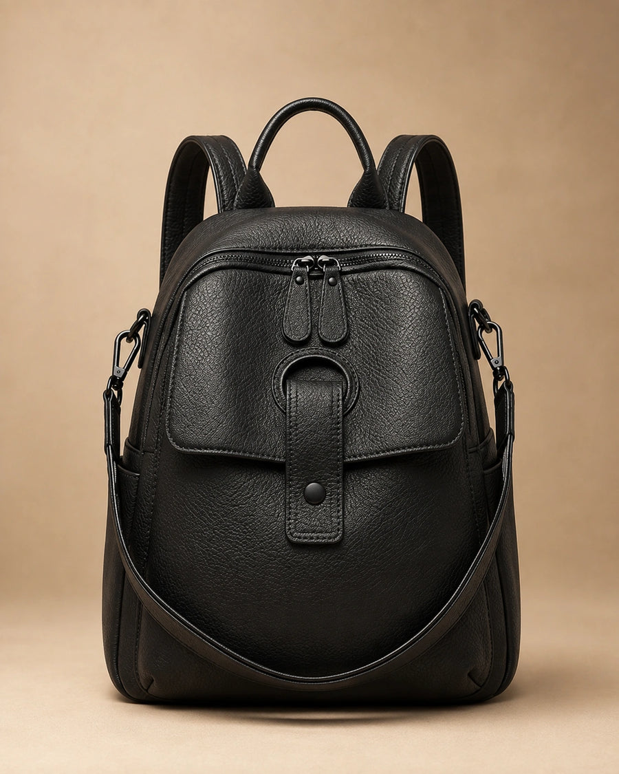 Front view of the Sloane genuine leather backpack showing the structured silhouette and top handle.