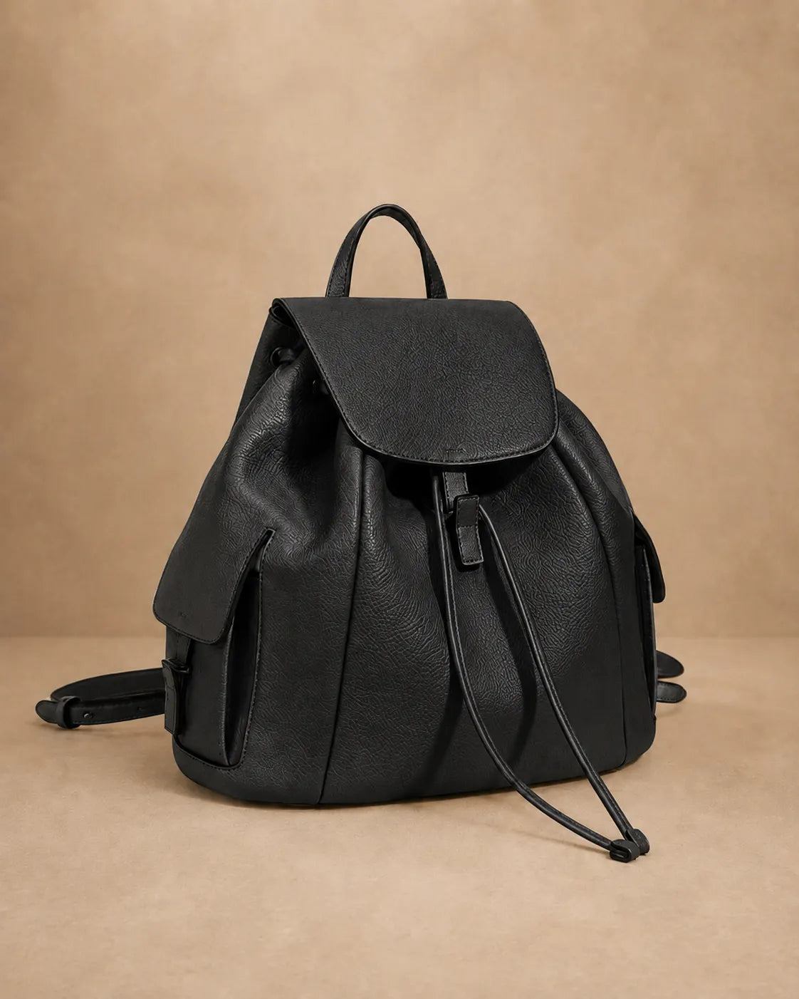 Close-up of the Genevieve leather backpack's cover-flap closure.