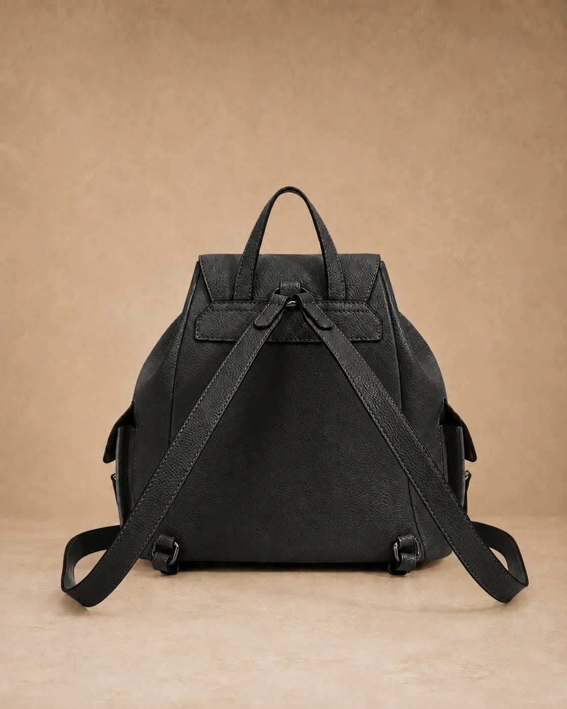 Side view of the Genevieve leather backpack highlighting its large capacity.