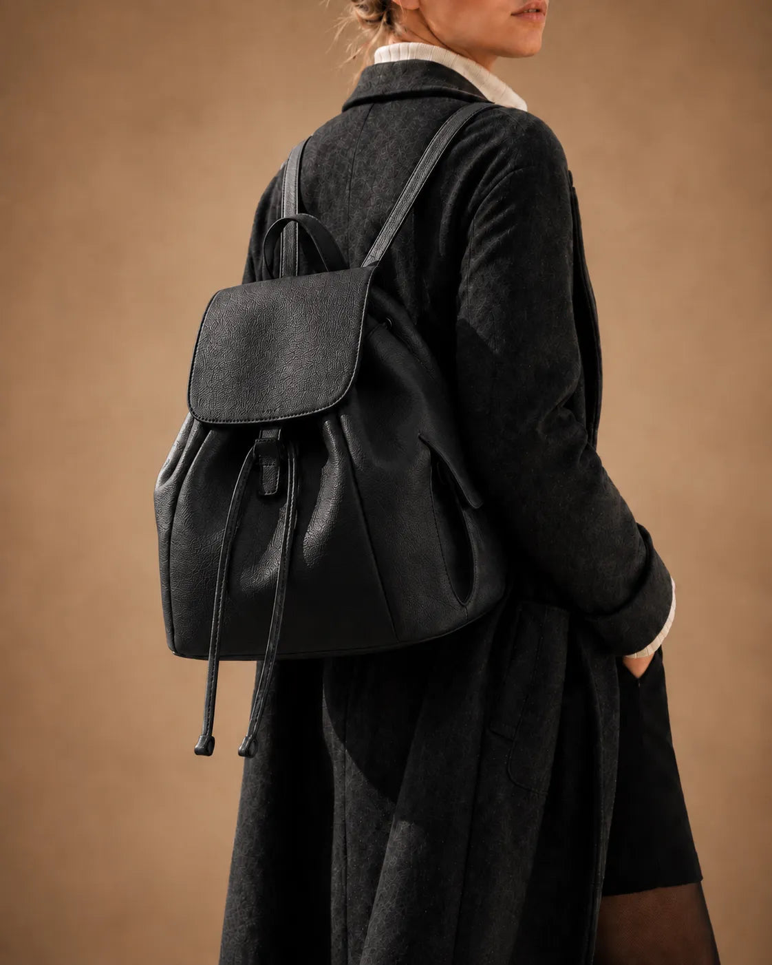Genevieve leather backpack worn on the back with adjustable straps.