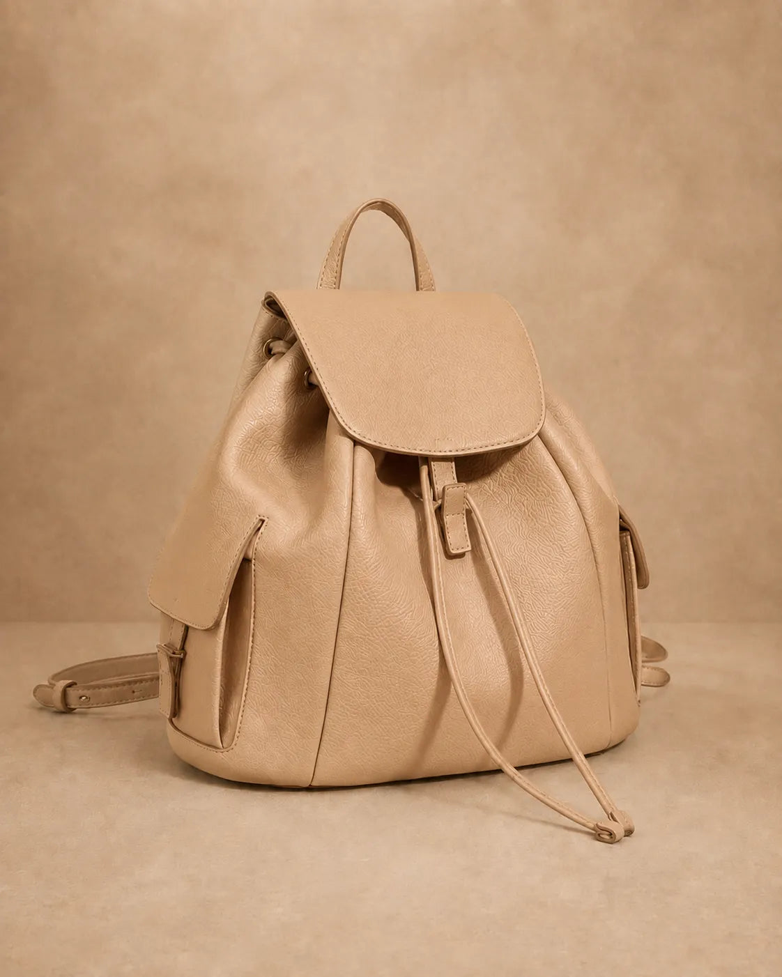 Detail view of the Genevieve leather backpack's stitching and leather texture.