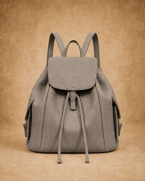Genevieve leather backpack shown carried by hand.
