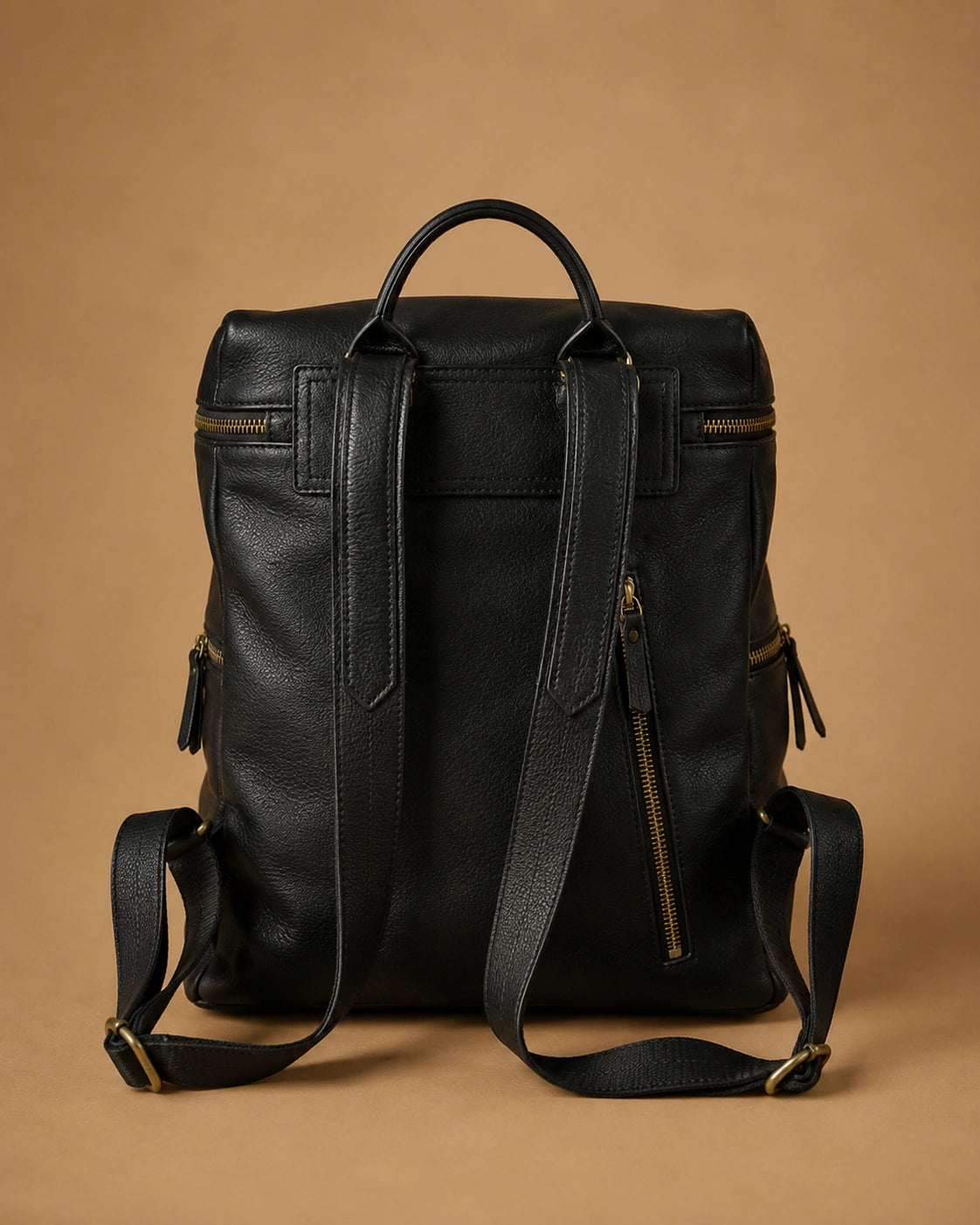 Close-up of the Adeline leather backpack's stitching and leather texture.