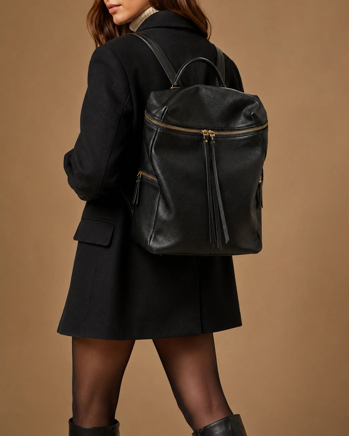 Adeline leather backpack worn on the back with adjustable straps.