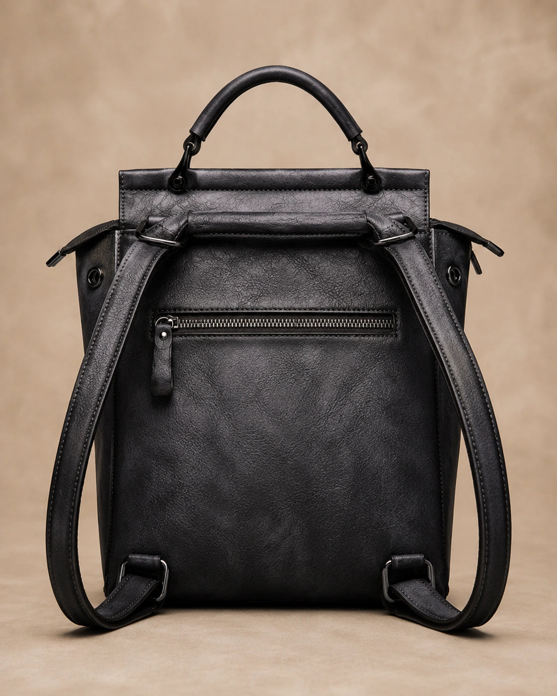 Interior view of the Odette leather backpack showing the zippered pockets and phone compartment.