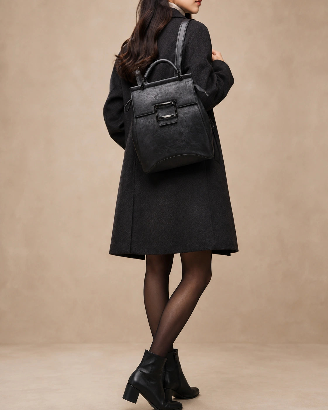 Odette leather backpack worn on the back with adjustable straps.