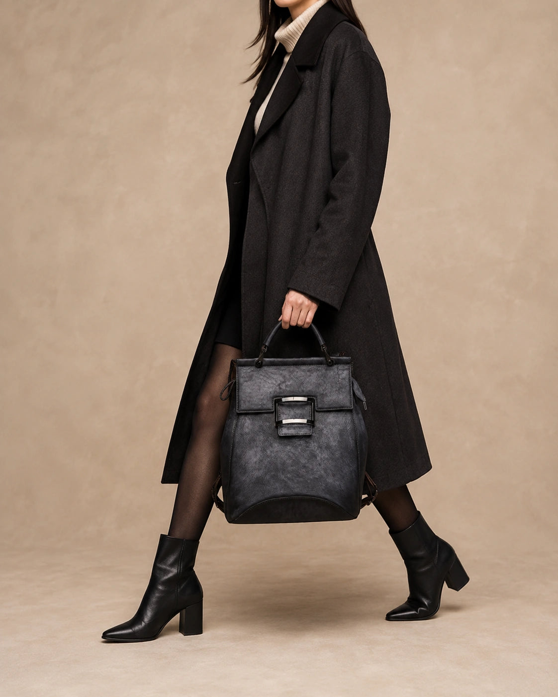 Odette leather backpack worn crossbody for versatile carrying.