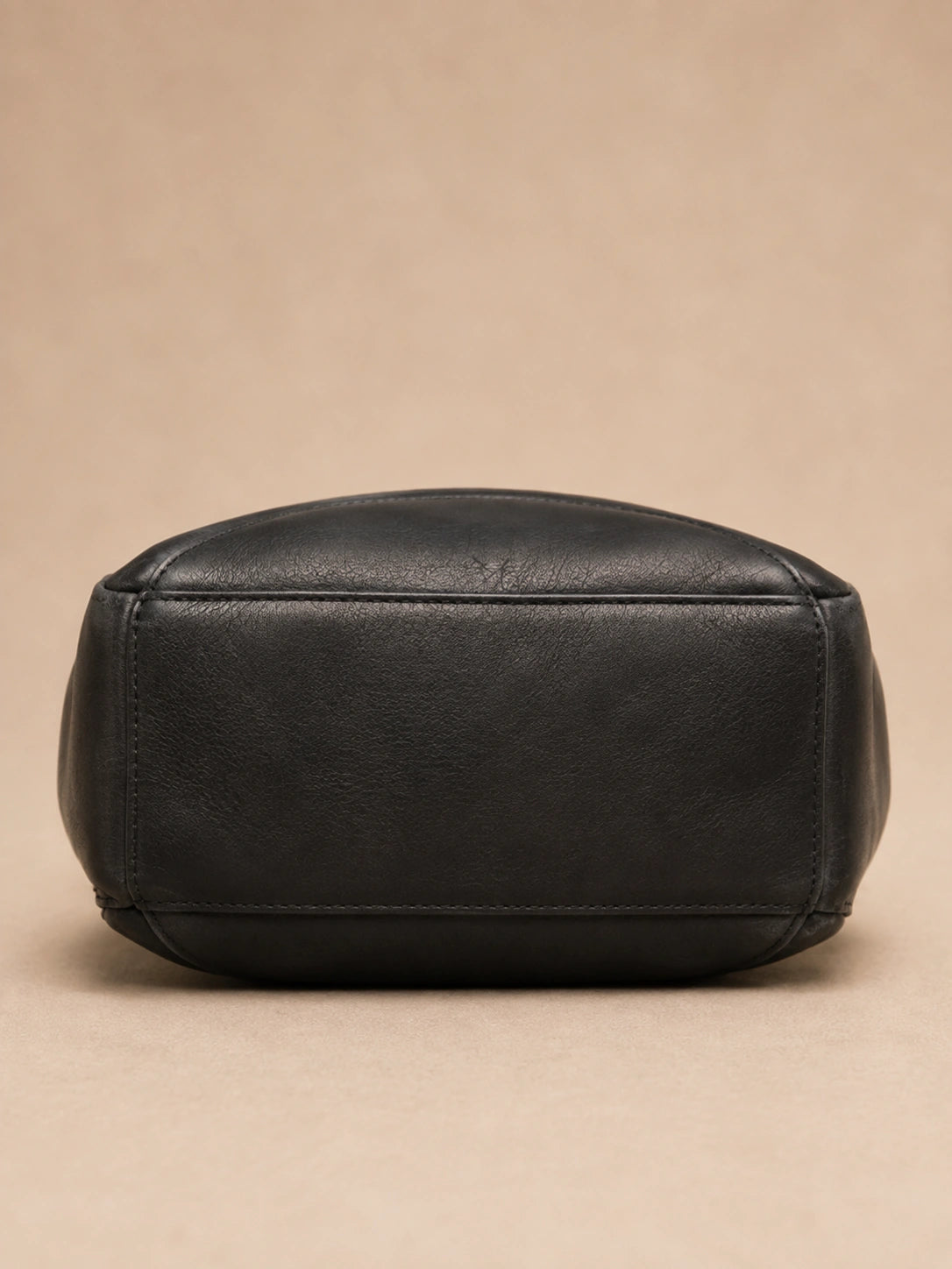 Side view of the Odette leather backpack highlighting the vintage silhouette.