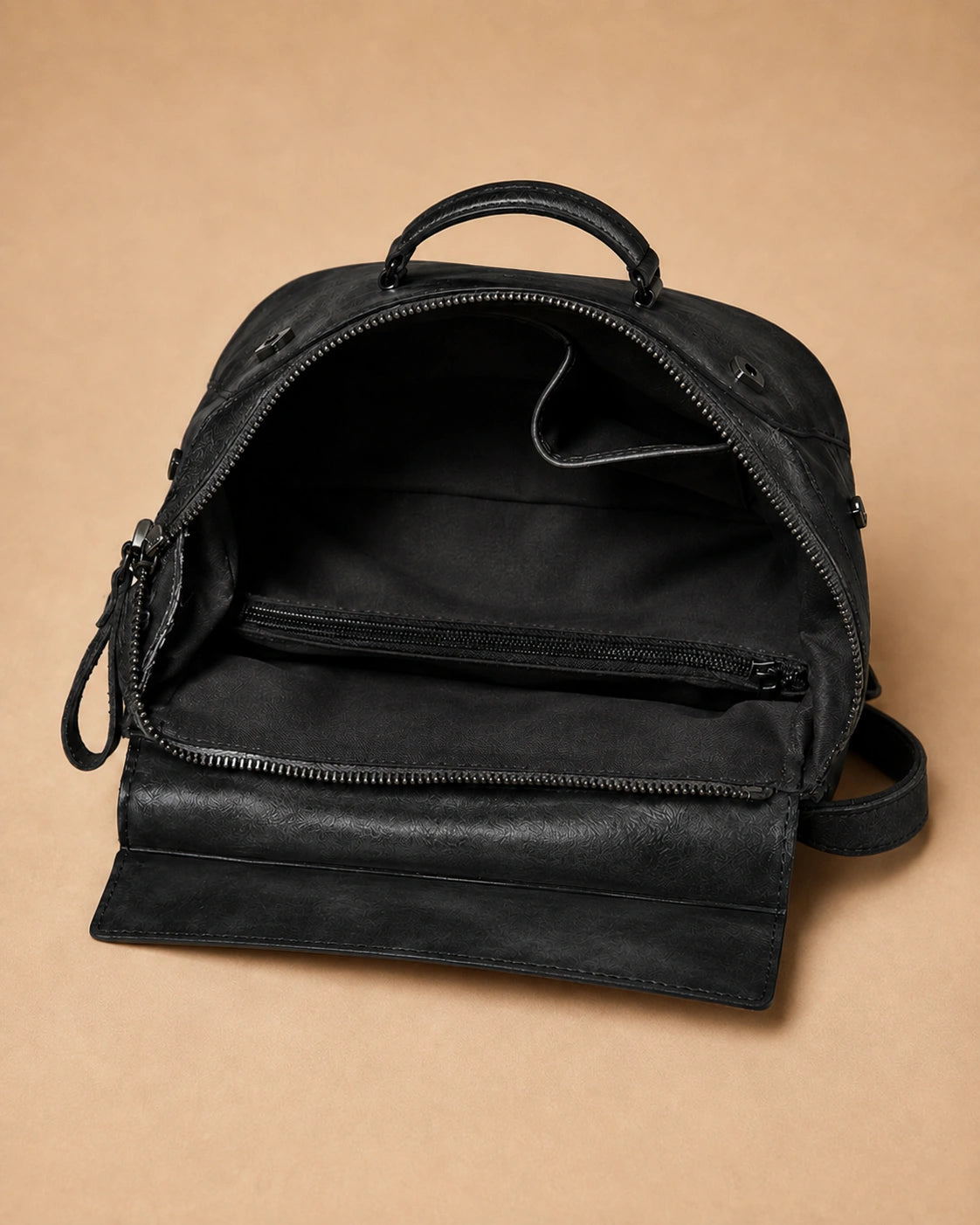 Detail view of the Odette leather backpack's natural leather texture and colour variation.