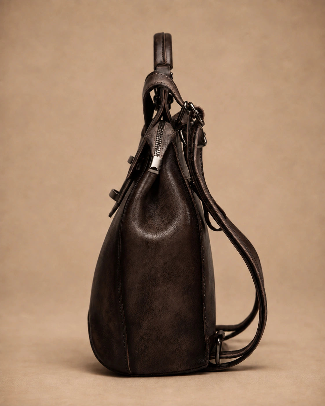Detail view of the Odette leather backpack's stitching and hardware.