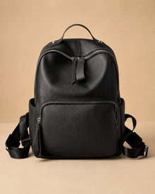 Front view of the Josephine genuine leather backpack showing the structured commuter silhouette.