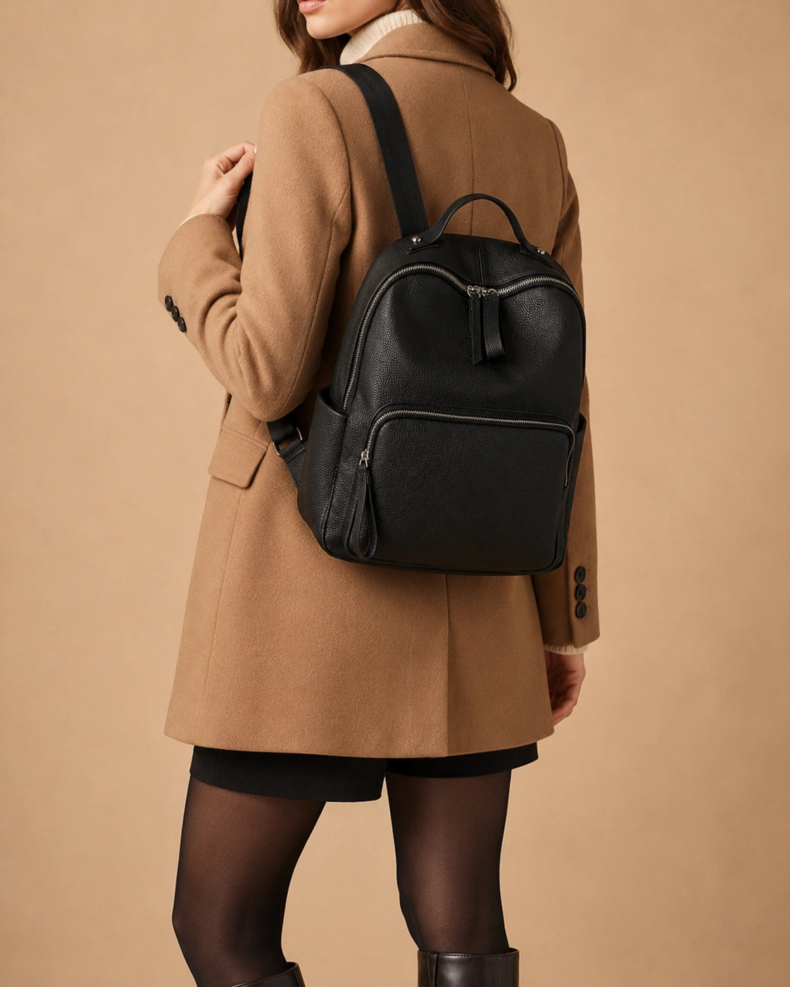 Side view of the Josephine leather backpack highlighting the clean structured shape.