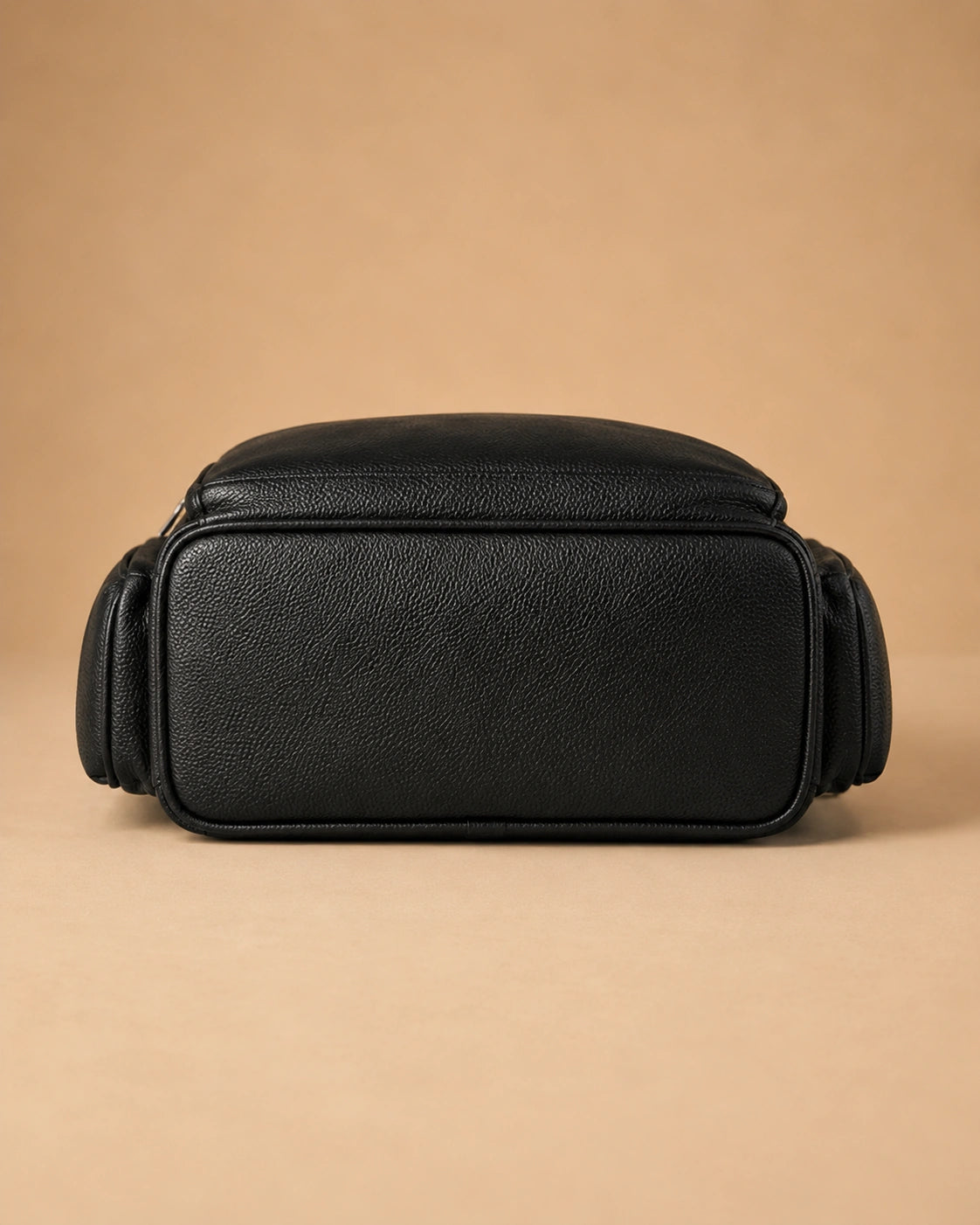 Detail view of the Josephine leather backpack's zip closure.
