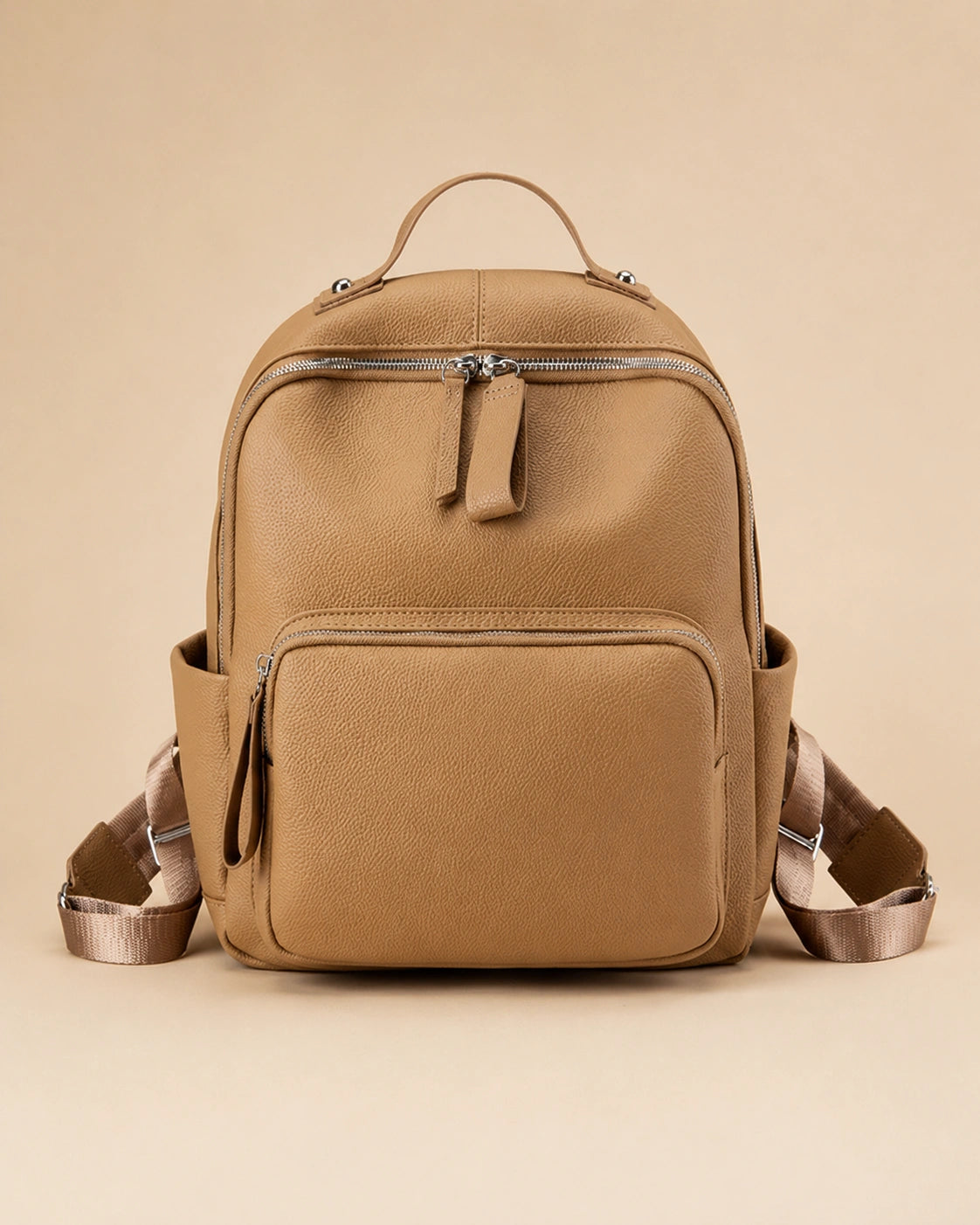 Josephine leather backpack shown carried by hand.
