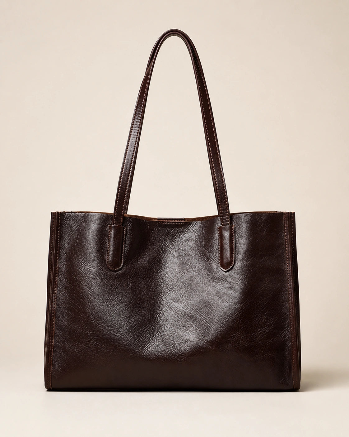 Angled front view of the Juliette large genuine leather tote bag in dark chocolate