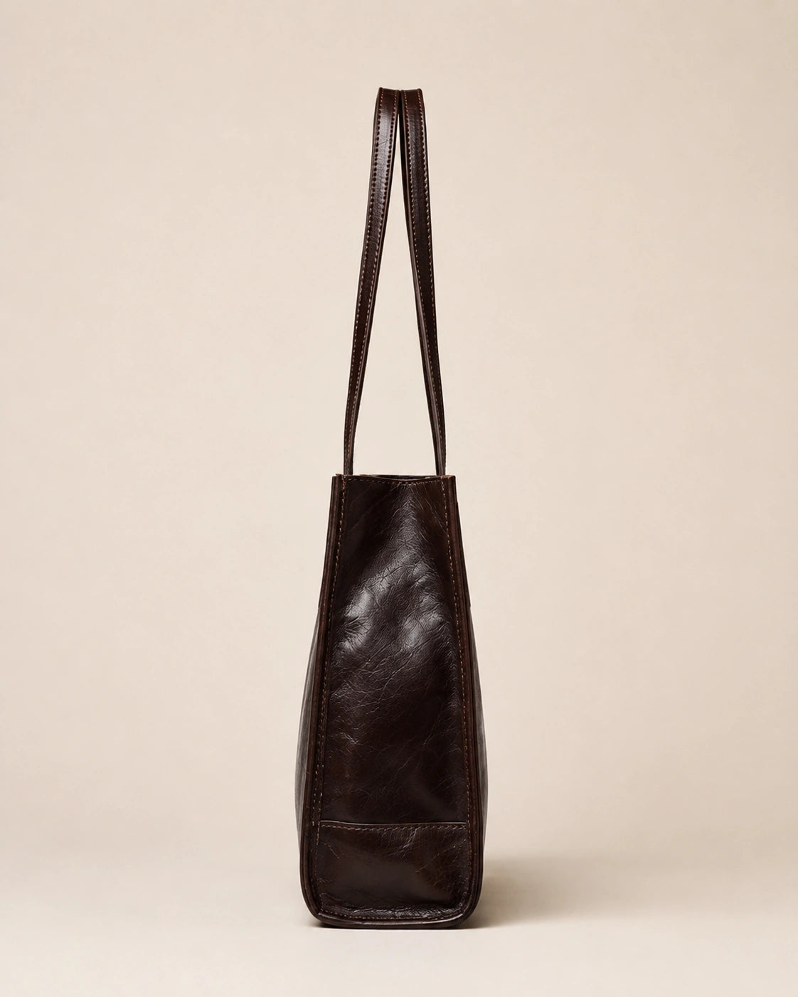 Side view of the Juliette large genuine leather tote bag in dark chocolate