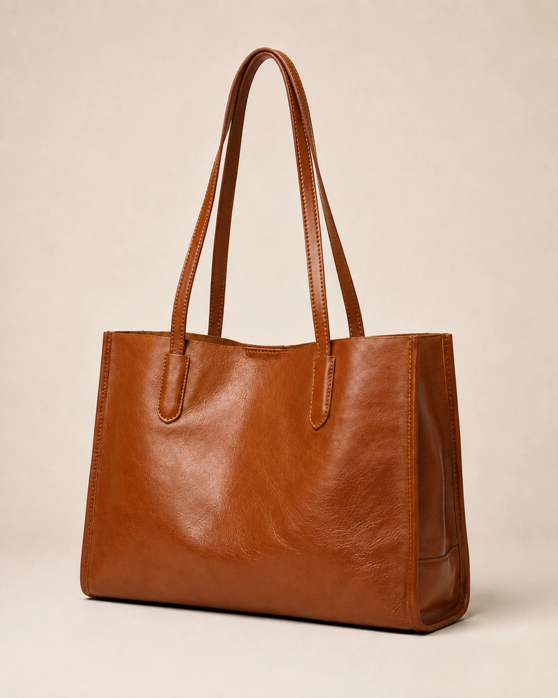 Angled front view of the Juliette large genuine leather tote bag in tan