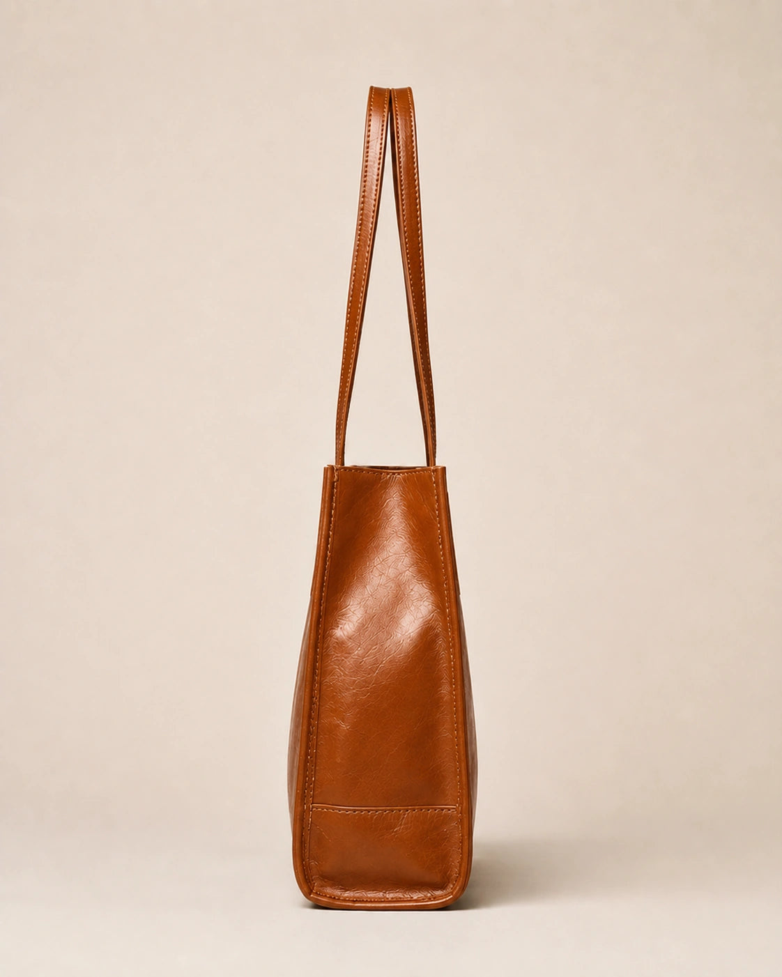Side view of the Juliette large genuine leather tote bag in tan