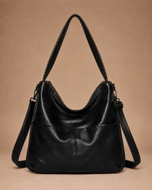 Detail view of the Marlowe genuine leather crossbody bag showing the zip closure.