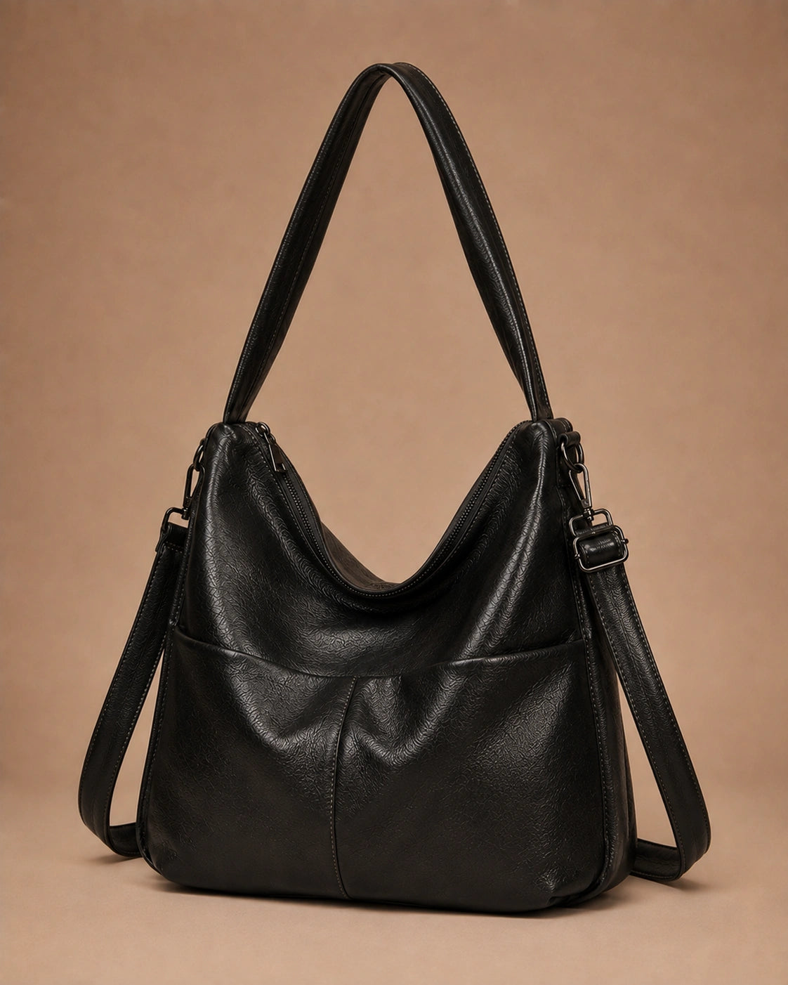 Base detail of the Marlowe genuine leather crossbody bag showing the structured construction.
