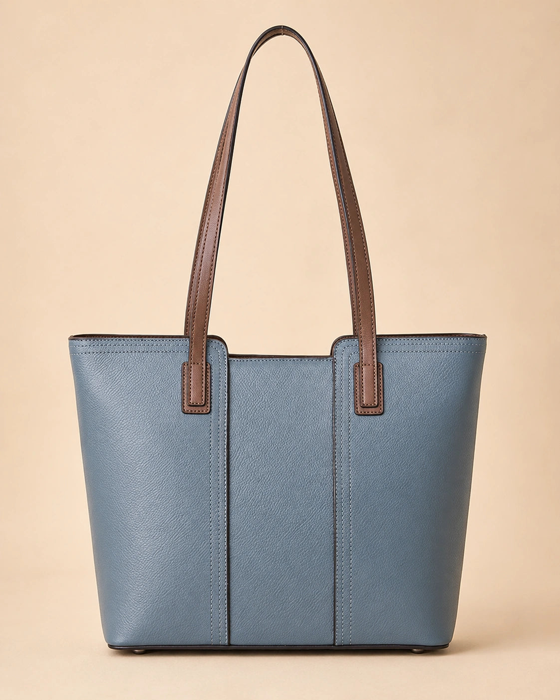 The Sienna genuine leather tote bag shown from a lifestyle angle, carried over the shoulder.