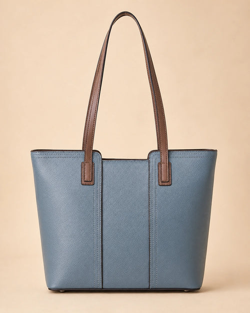 The Sienna genuine leather tote bag shown from a lifestyle angle, carried over the shoulder.